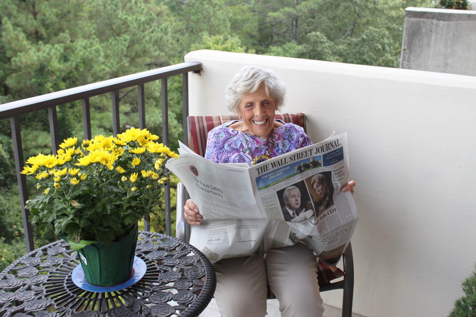 Lady Reading Newspaper on balcony