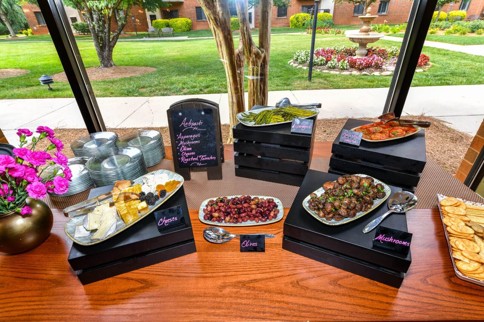 A table with several trays of food on it.