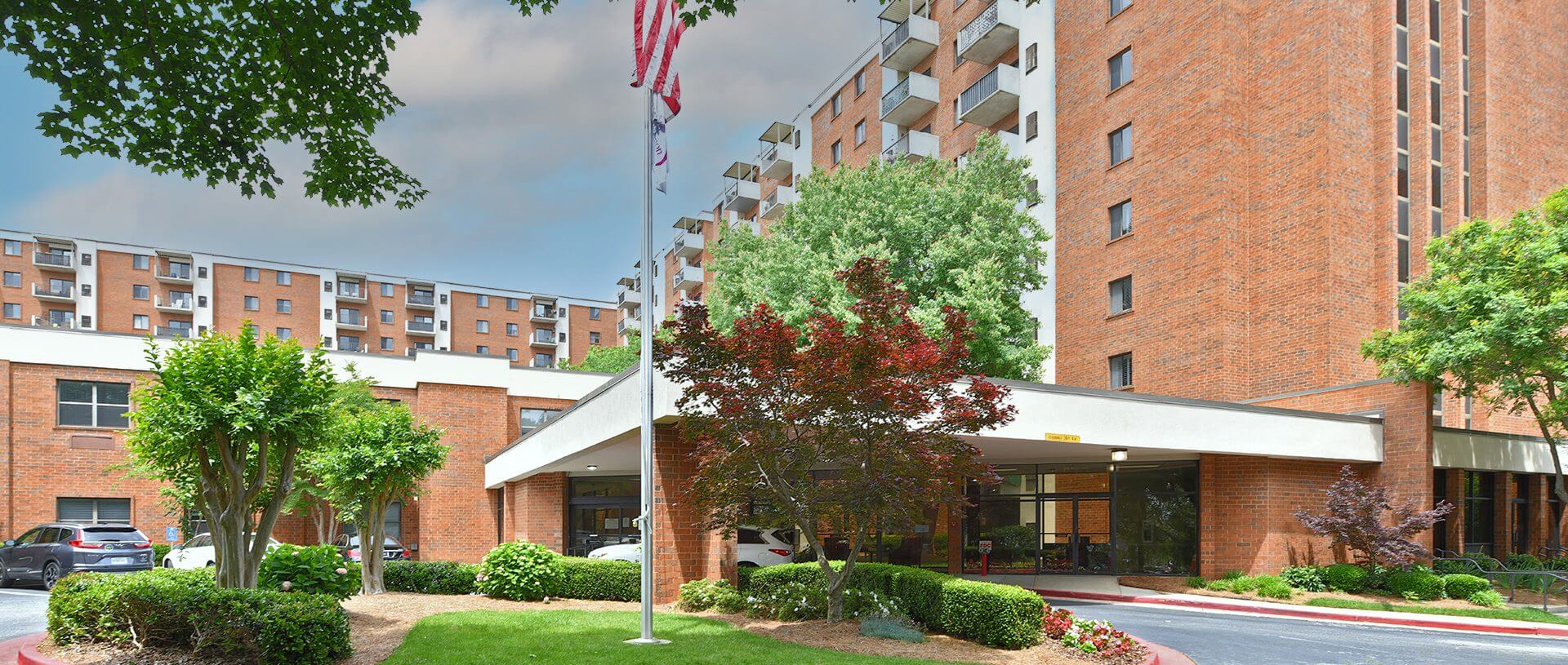 Brick apartment building entrance with flagpole