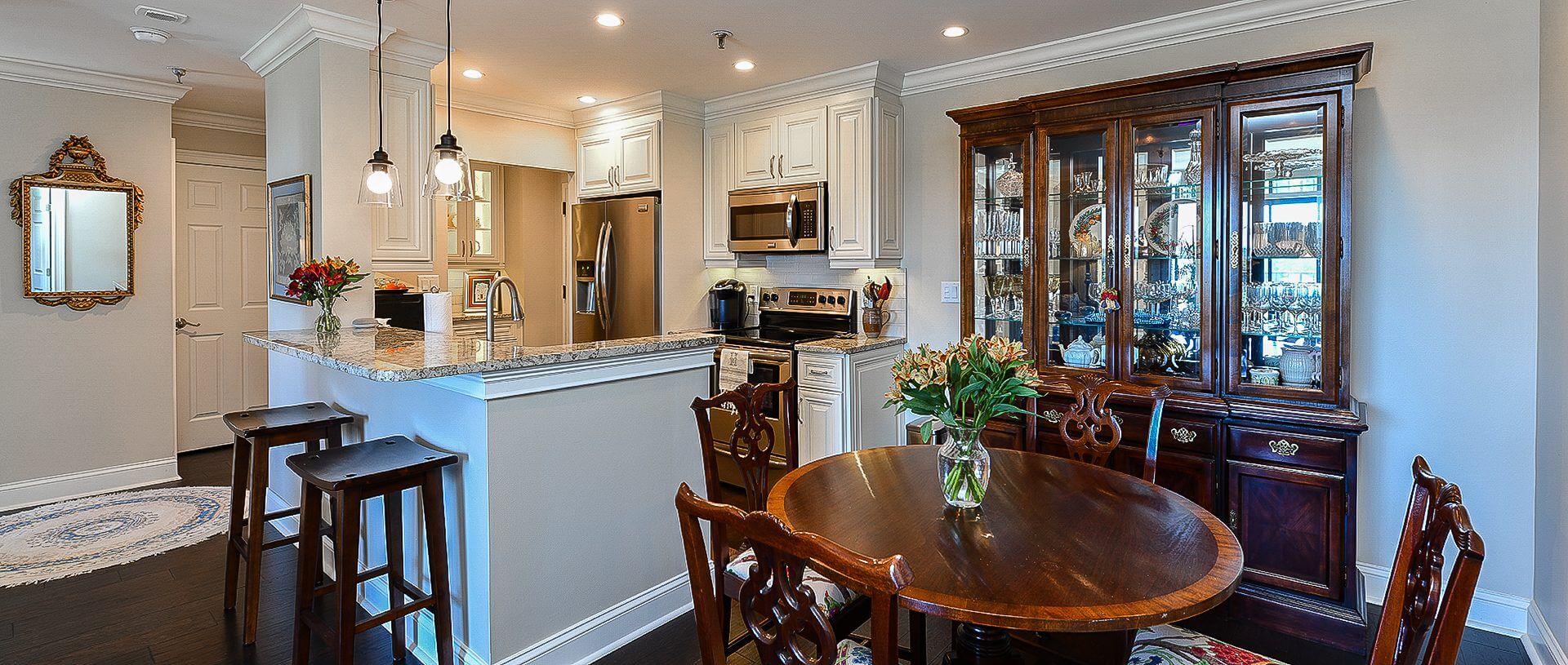 A kitchen with a dining table and chairs